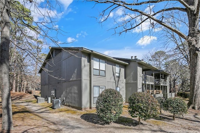 view of side of home with a balcony and central AC unit