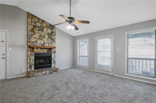 unfurnished living room with vaulted ceiling, ceiling fan, a fireplace, and carpet floors