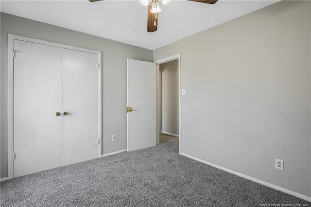 unfurnished bedroom with ceiling fan, a closet, and carpet