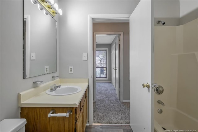 full bathroom featuring shower / tub combination, vanity, and toilet