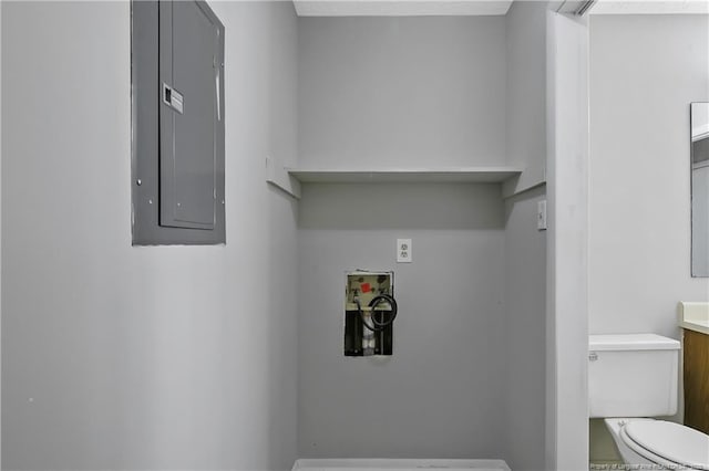 clothes washing area featuring electric panel and hookup for a washing machine