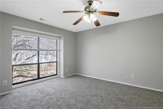 unfurnished room featuring ceiling fan and carpet flooring