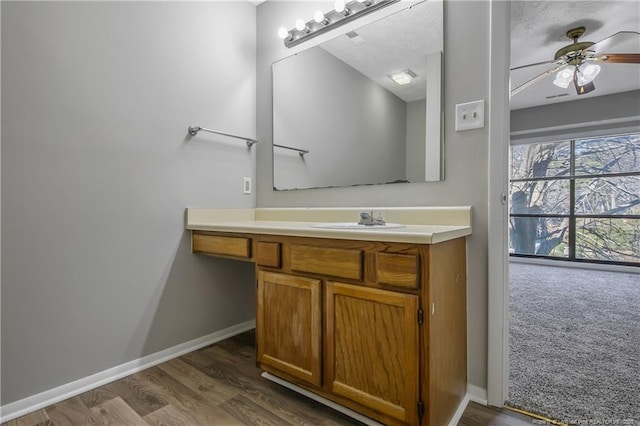 bathroom featuring vanity, wood-type flooring, and ceiling fan