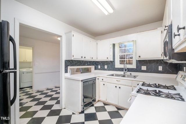 kitchen featuring black appliances, washer / dryer, decorative backsplash, sink, and white cabinetry