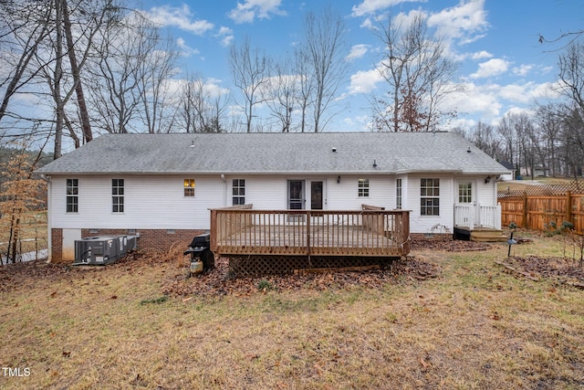 back of house with cooling unit, a yard, and a deck