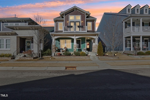 view of front of home with a balcony and covered porch