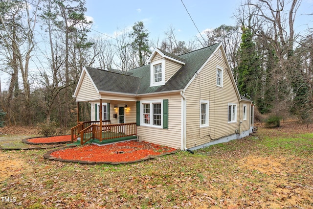 view of front of property with covered porch and a front yard