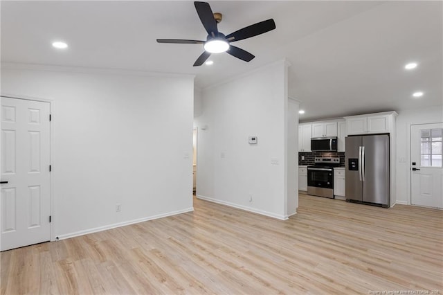 unfurnished living room featuring ornamental molding, ceiling fan, and light wood-type flooring