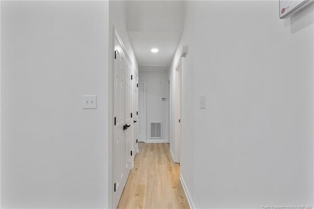 corridor with light wood-type flooring