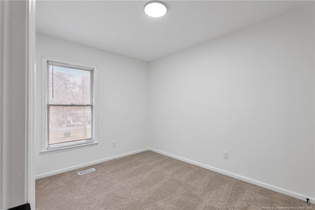 spare room with light colored carpet