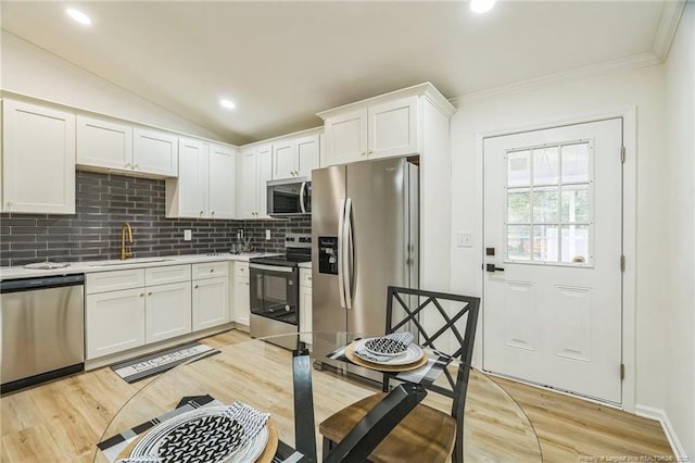 5802 Lillie Dr, Durham, NC 27712 - kitchen featuring stainless steel appliances, a sink, backsplash, white cabinets, and light countertops
