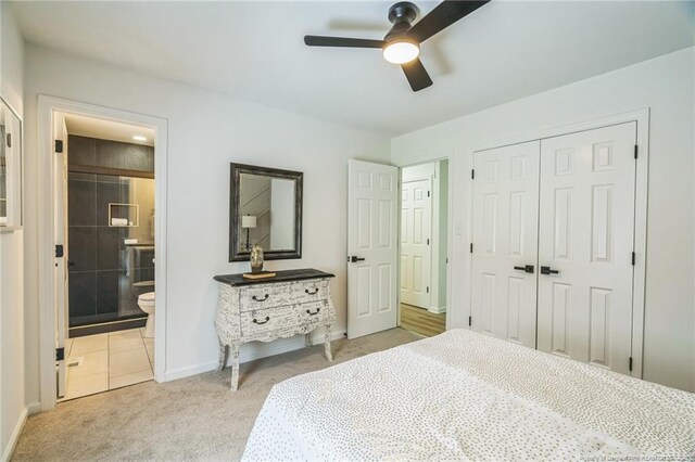 5802 Lillie Dr, Durham, NC 27712 - bedroom with a closet, baseboards, light carpet, ensuite bathroom, and ceiling fan