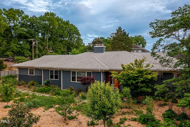 view of front of home featuring a shingled roof and a chimney