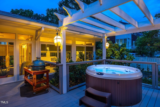 wooden terrace with fence, a pergola, and a hot tub