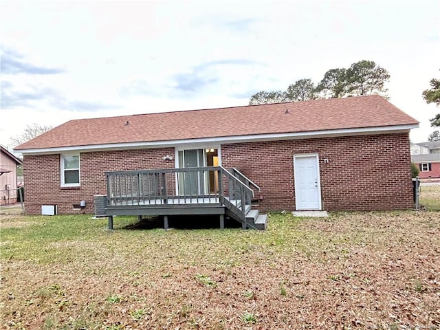 rear view of house with a yard and a deck