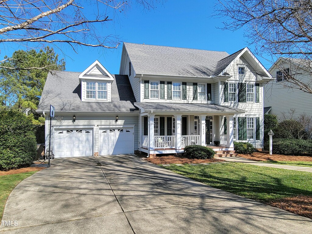 1617 Heritage Club Ave, Wake Forest, NC 27587 - view of front facade featuring a front yard, covered porch, an attached garage, and concrete driveway