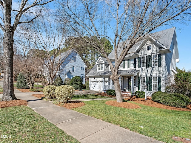 view of front facade with a garage and a front yard