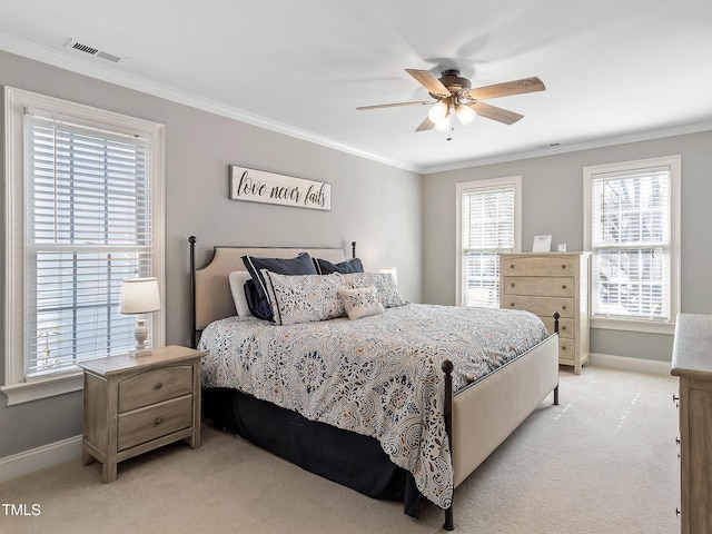 bedroom with visible vents, crown molding, light carpet, and baseboards