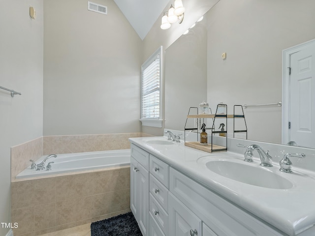 full bath featuring vaulted ceiling, a sink, visible vents, and a bath