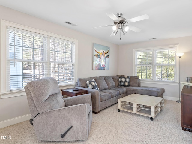 living area with visible vents, ceiling fan, and baseboards