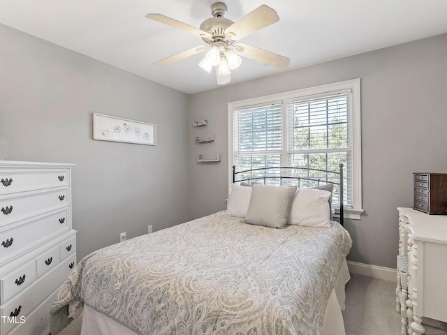 carpeted bedroom featuring ceiling fan and baseboards