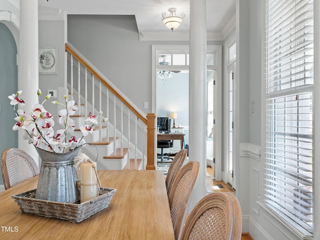 dining room featuring stairs and crown molding