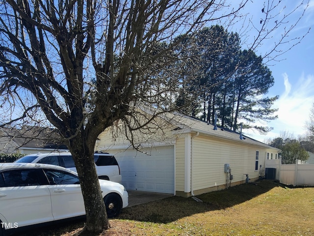 view of property exterior with a garage, fence, and cooling unit