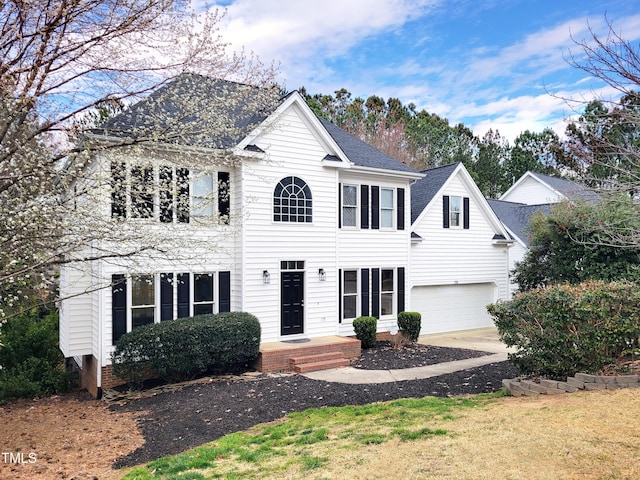 colonial home featuring driveway and a garage