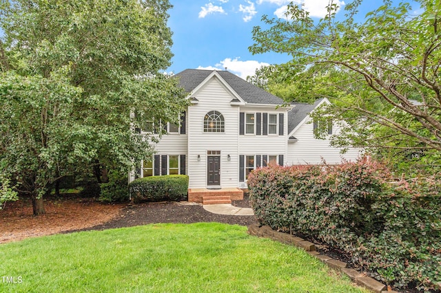 725 Littleleaf Ct, Holly Springs, NC 27540 - colonial house featuring a front lawn and roof with shingles