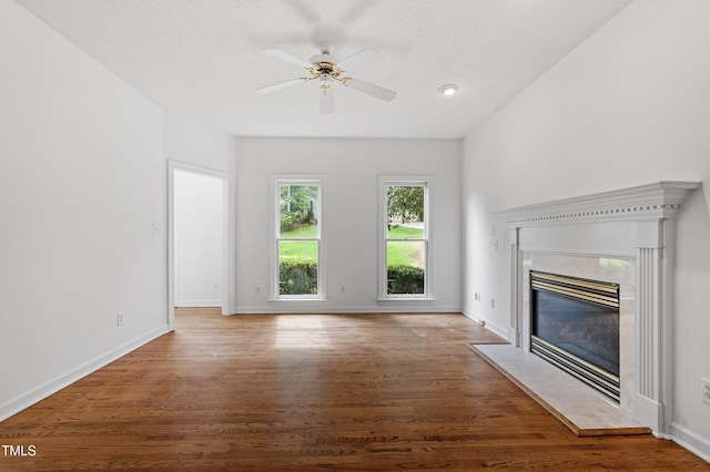 725 Littleleaf Ct, Holly Springs, NC 27540 - unfurnished living room with wood finished floors, a ceiling fan, and a fireplace