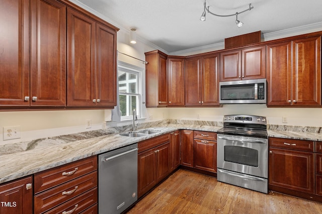 725 Littleleaf Ct, Holly Springs, NC 27540 - kitchen featuring stainless steel appliances, light wood finished floors, light stone counters, and ornamental molding