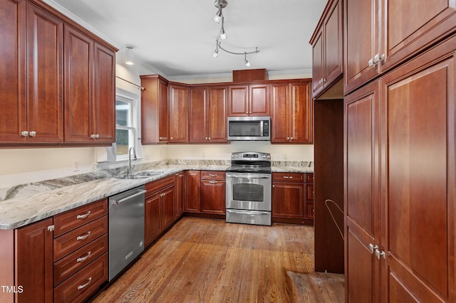 725 Littleleaf Ct, Holly Springs, NC 27540 - kitchen with appliances with stainless steel finishes, wood finished floors, and light stone counters