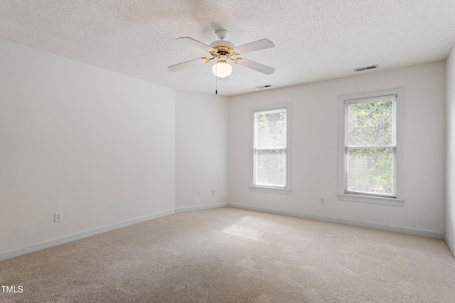 725 Littleleaf Ct, Holly Springs, NC 27540 - spare room with a textured ceiling, light colored carpet, and a ceiling fan