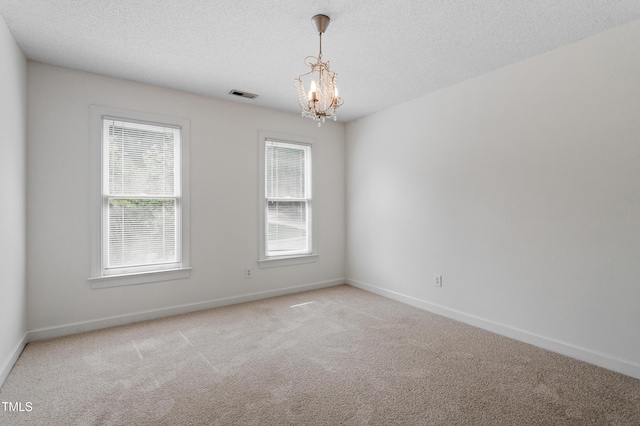 725 Littleleaf Ct, Holly Springs, NC 27540 - spare room with a chandelier, light colored carpet, and a textured ceiling