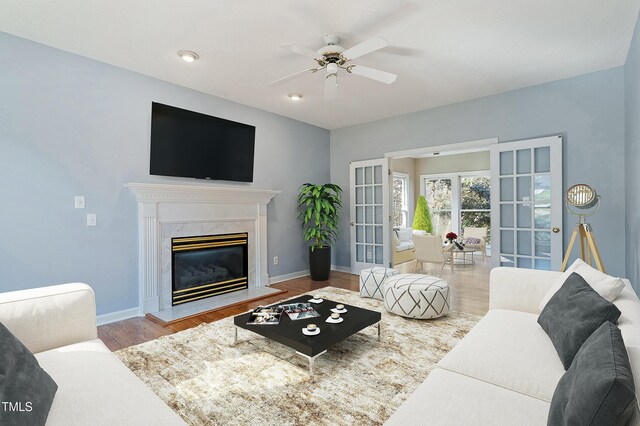 725 Littleleaf Ct, Holly Springs, NC 27540 - living room with ceiling fan, wood finished floors, french doors, and a premium fireplace