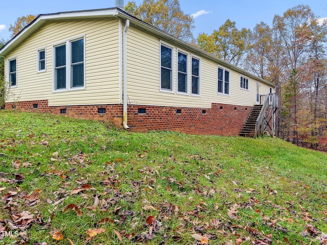 view of side of home featuring a yard