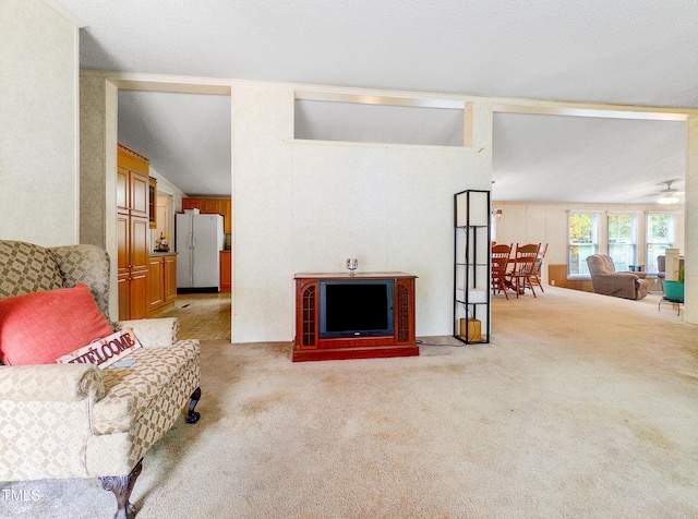 carpeted living room featuring vaulted ceiling