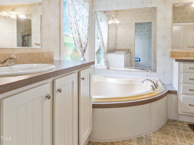 bathroom with vanity and a bath