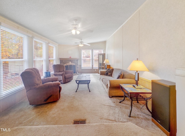 carpeted living room featuring a textured ceiling and ceiling fan