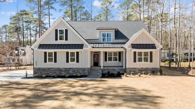 modern inspired farmhouse with roof with shingles, a porch, board and batten siding, a standing seam roof, and metal roof