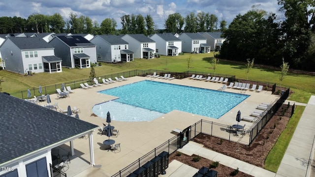 view of pool featuring a lawn and a patio