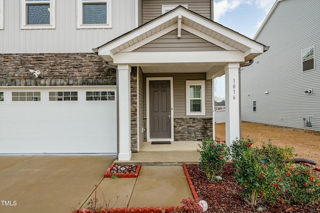 entrance to property featuring a garage and covered porch