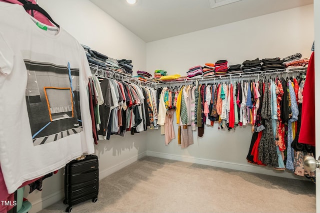 walk in closet with carpet