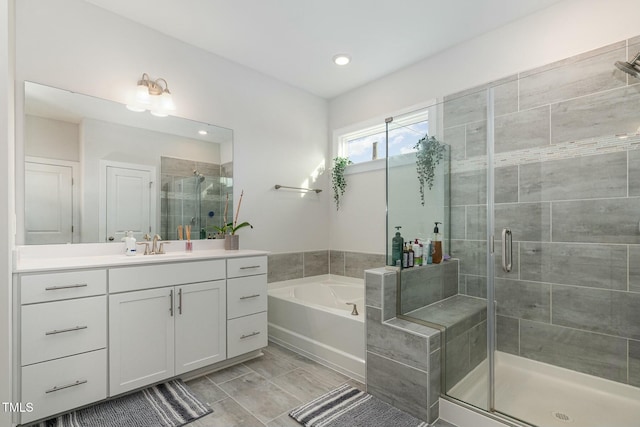 bathroom with independent shower and bath and vanity