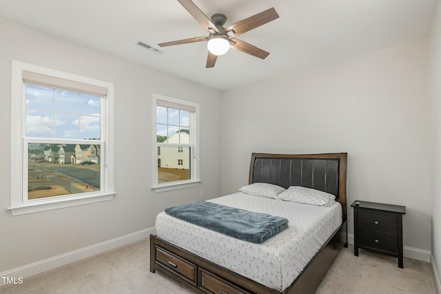 bedroom featuring light carpet and ceiling fan