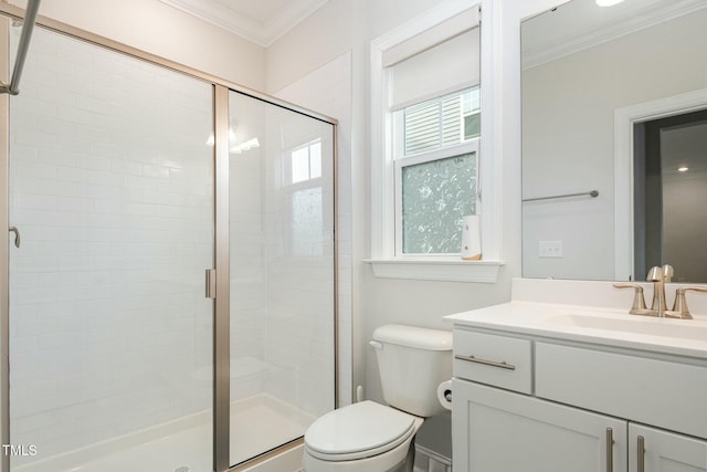 bathroom featuring ornamental molding, toilet, a wealth of natural light, and walk in shower