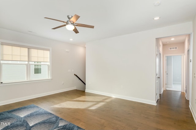 spare room featuring dark hardwood / wood-style flooring and ceiling fan