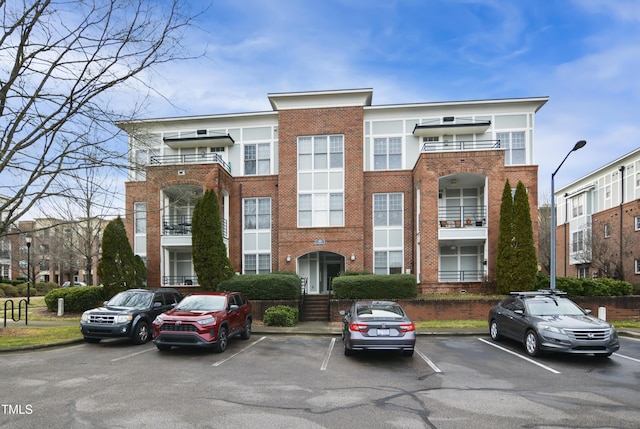 view of building exterior featuring uncovered parking