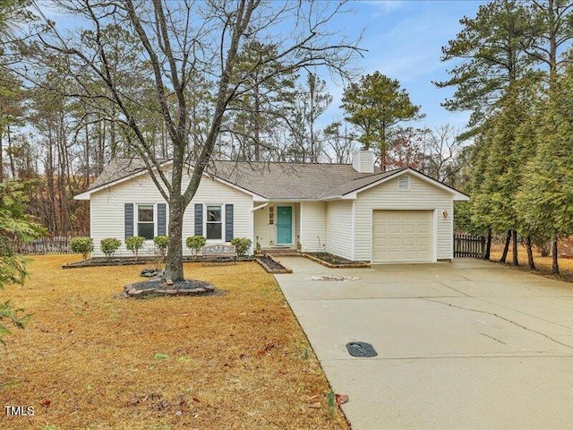 ranch-style home with a garage and a front lawn