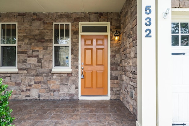 532 Front Ridge Dr, Cary, NC 27519 - view of exterior entry featuring stone siding and a porch